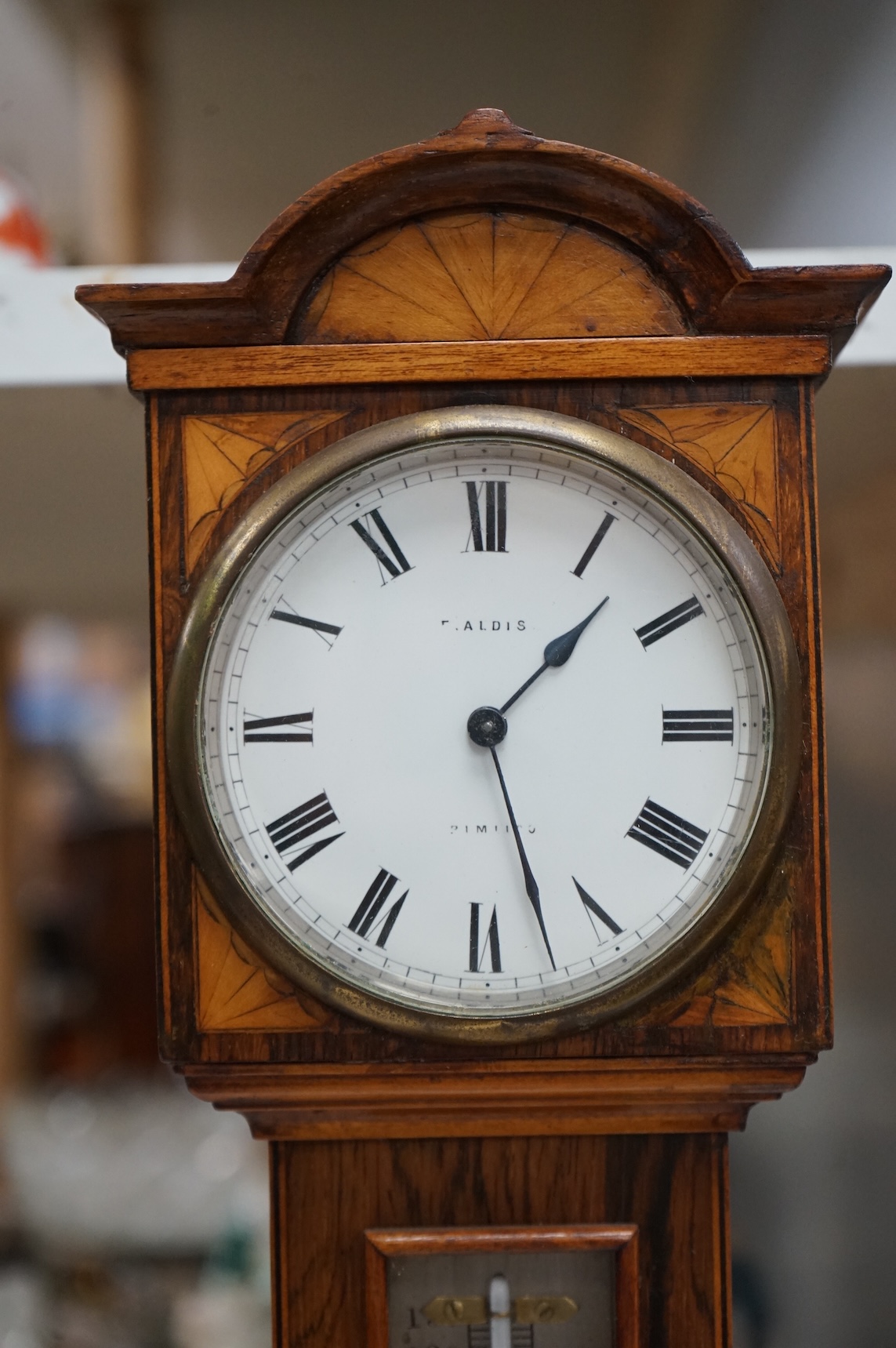 A miniature inlaid rosewood longcase clock with French movement and integral aneroid barometer and thermometer, the dial inscribed Aldis, Pimlico, 47cm high